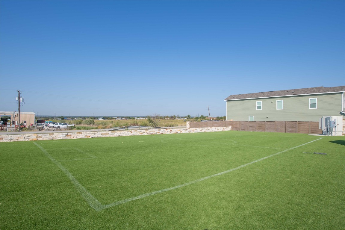 309 Marty Allen Loop Jarrell, TX 76537 - Photo 16 of 30 a view of a field and a building in the background