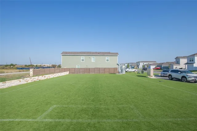 a swimming pool with outdoor seating and yard