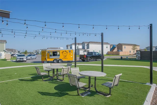 a view of a street with a house in the background
