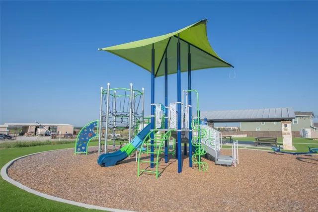 a view of a house with a yard and table and chair