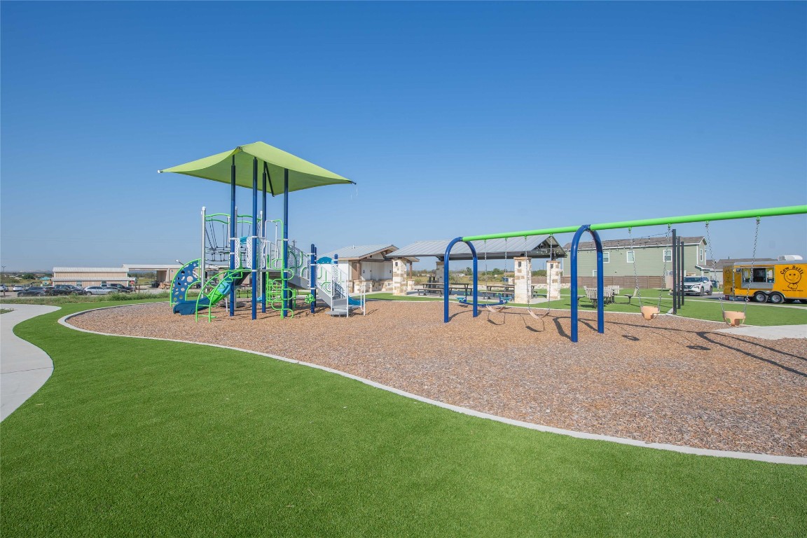 309 Marty Allen Loop Jarrell, TX 76537 - Photo 23 of 30 Communal playground with a yard