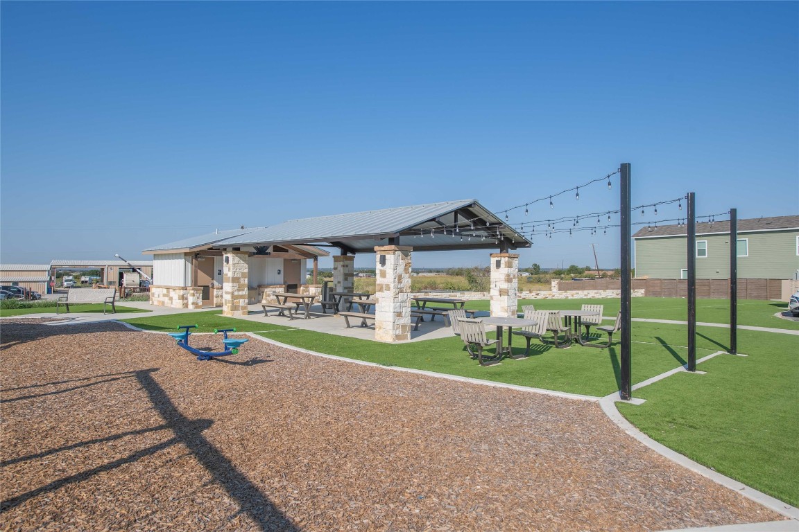 309 Marty Allen Loop Jarrell, TX 76537 - Photo 24 of 30 View of community featuring a patio and a yard