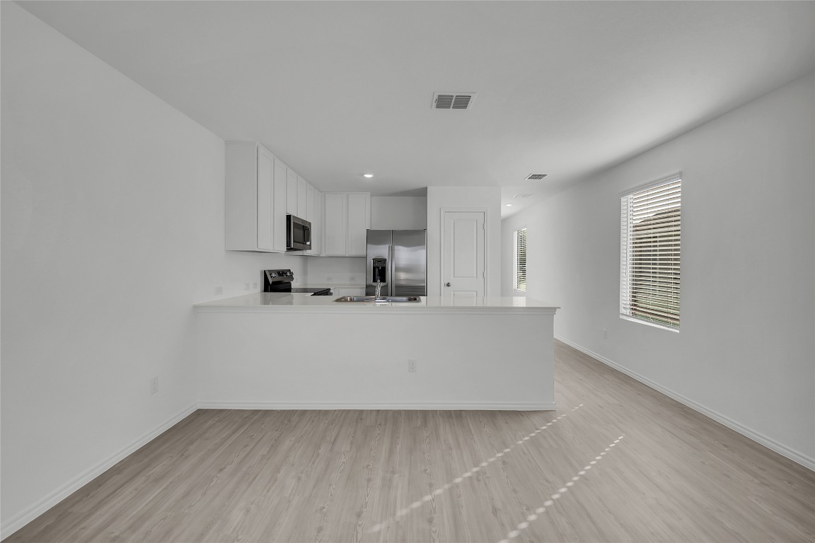 309 Marty Allen Loop Jarrell, TX 76537 - Photo 3 of 30 a view of kitchen with stainless steel appliances refrigerator sink and cabinets