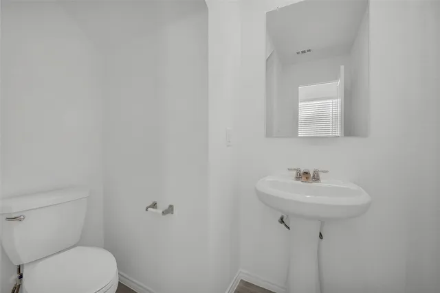 a bathroom with a sink toilet