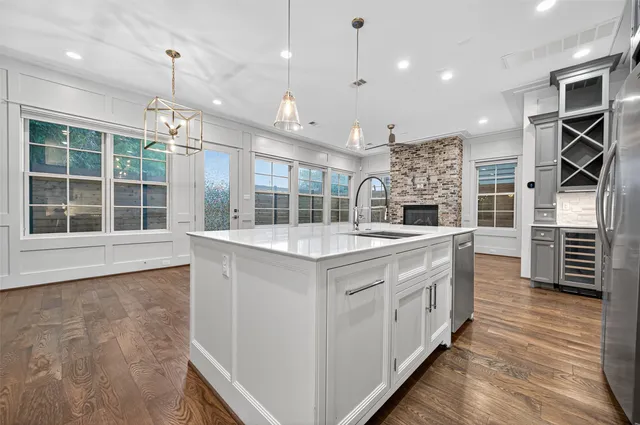 a utility room with stainless steel appliances granite countertop a stove and a refrigerator