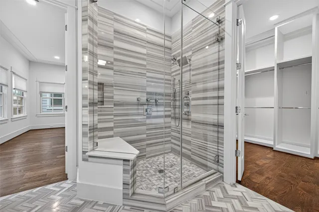 a bedroom with a bed and glass window