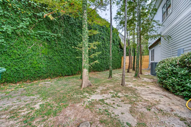 a view of house with yard and green space