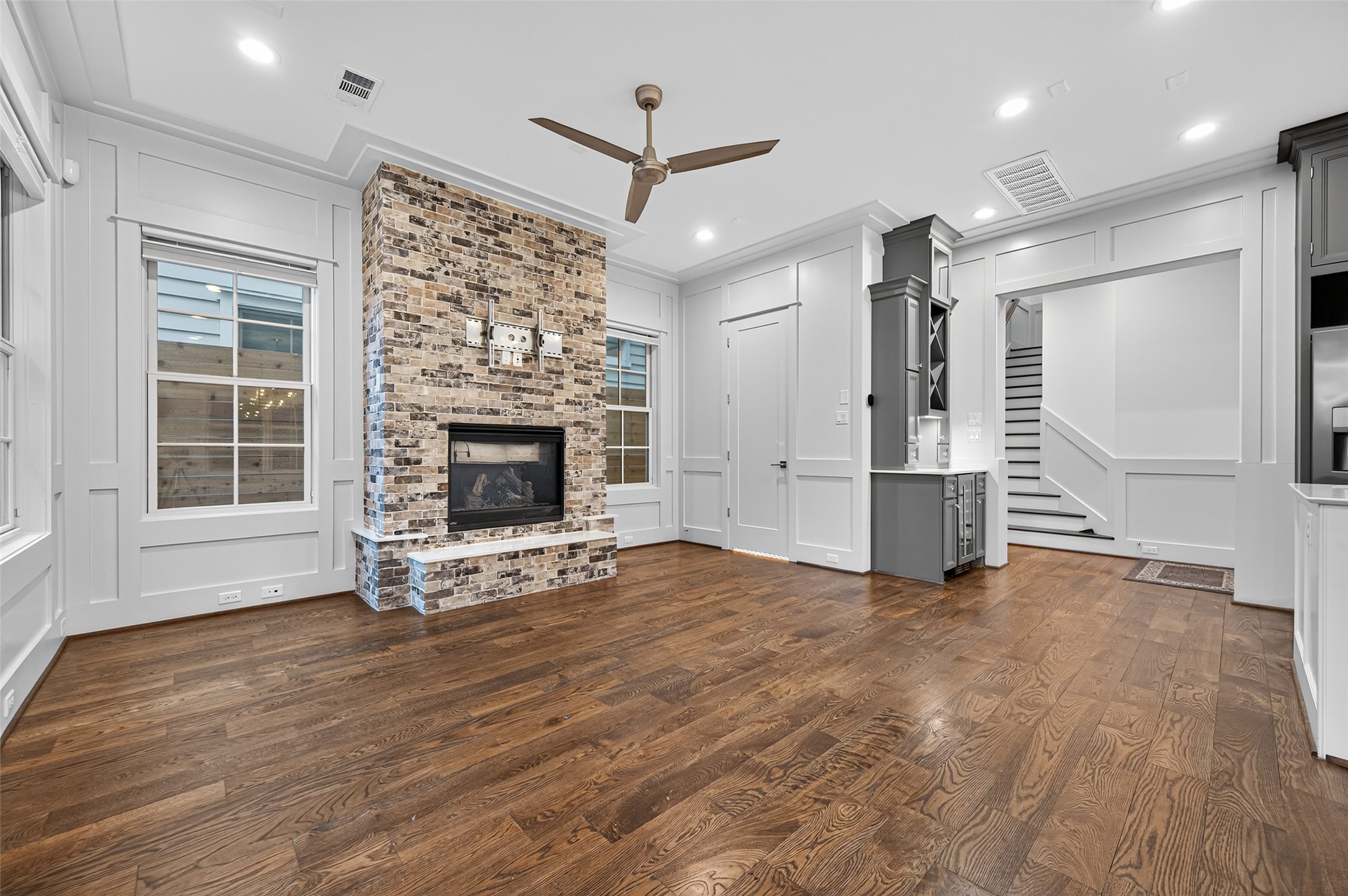 428 Marshall Street Houston, TX 77006 - Photo 7 of 36 an empty room with wooden floor fireplace and windows