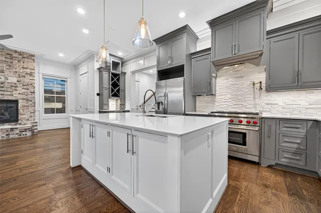 a kitchen with stainless steel appliances granite countertop a refrigerator and a sink