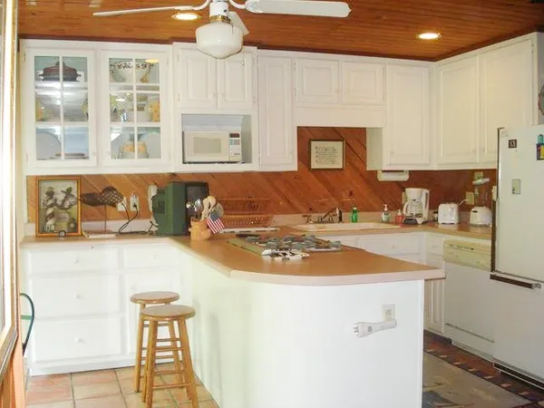 a view of a kitchen with granite countertop a sink and a stove