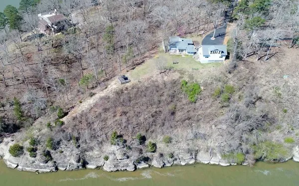 a view of a yard with wooden fence
