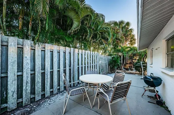 a view of a chairs and table in backyard