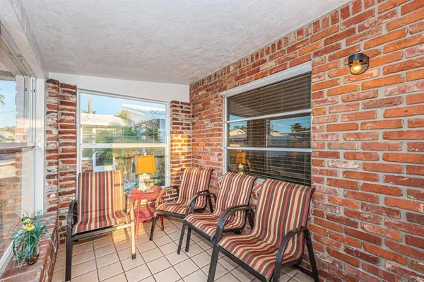 a view of a chairs and table in the balcony