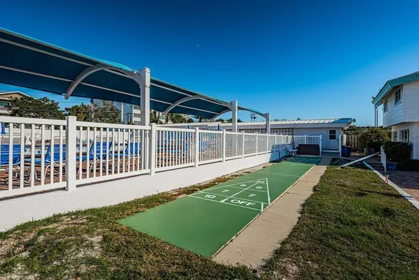a view of a house with backyard porch and sitting area
