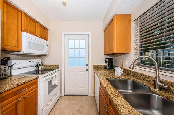 a kitchen with stainless steel appliances granite countertop a sink stove and cabinets