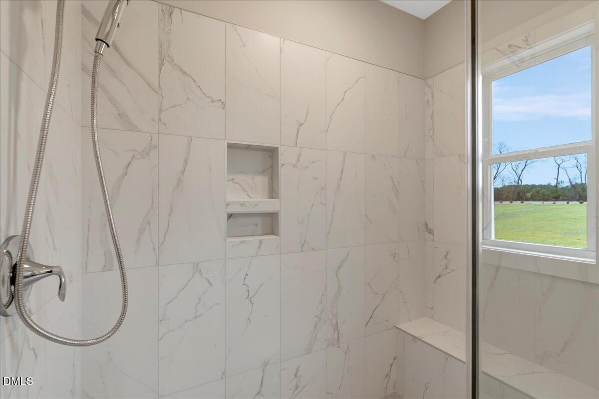 2280 Heartland Road Battleboro, NC 27809 - Photo 28 of 46 a bathroom with a white shower a vanity and a window