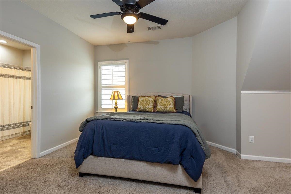 608 Cypress Run Cove Collierville, TN 38017 - Photo 28 of 40 Bedroom featuring ensuite bath, ceiling fan, and light carpet