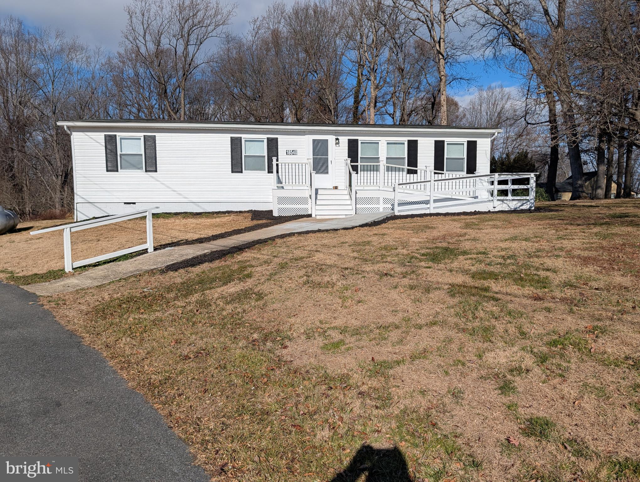 a view of a white house with a yard