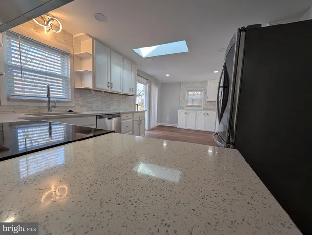 a view of a kitchen with a sink and cabinets