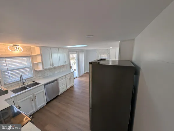 a kitchen with stainless steel appliances granite countertop a refrigerator and a stove