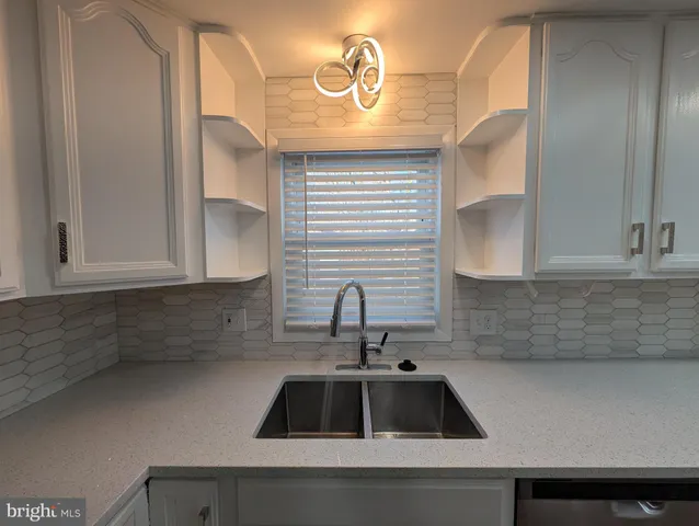 a kitchen with a sink and cabinets