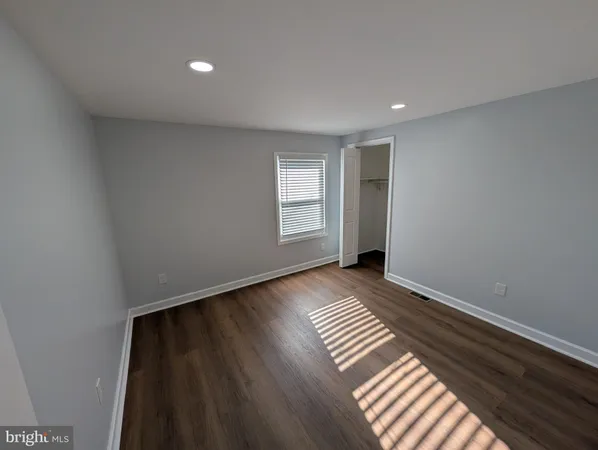 a view of wooden floor and windows in a room