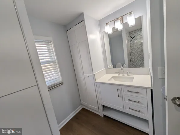 a bathroom with a double vanity sink and mirror