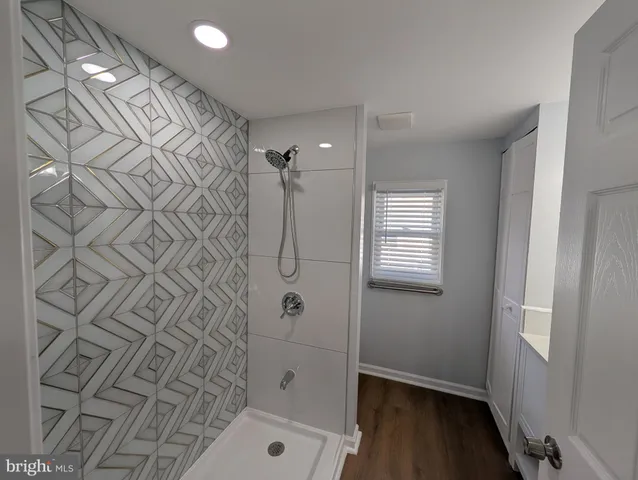 a bathroom with a bathtub and shower