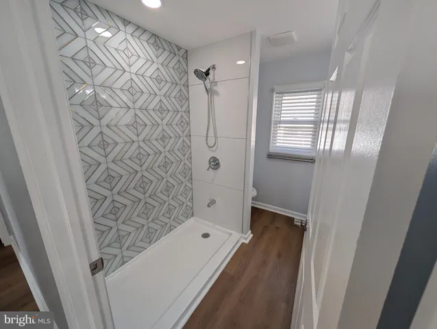 a bathroom with a bathtub and shower