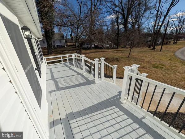 a view of a balcony with wooden floor and fence