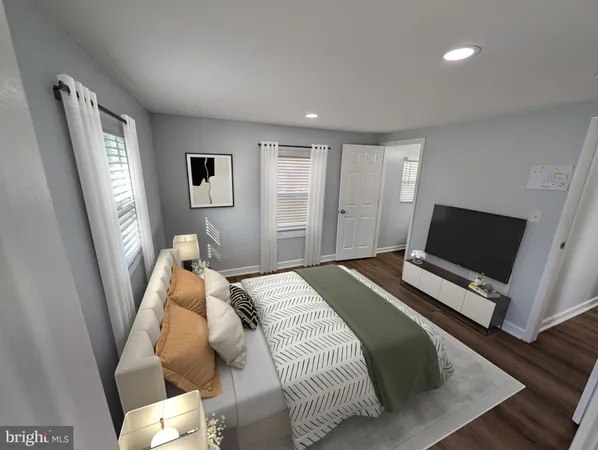 a bedroom with a bed and a television