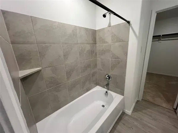 a bathroom with a granite countertop sink a toilet and bathtub