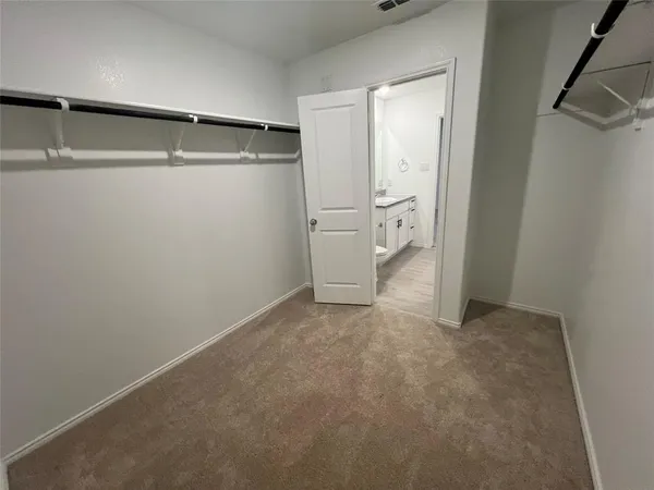 a view of a kitchen with a sink and a refrigerator