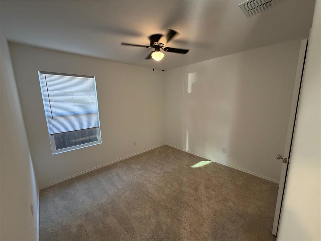 9012 Red Fox Trail McKinney, TX 75071 - Photo 24 of 35 an empty room with a window and a fan