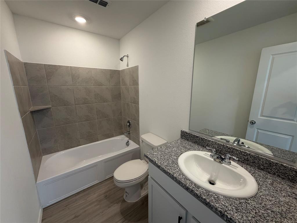 9012 Red Fox Trail McKinney, TX 75071 - Photo 25 of 35 a bathroom with a granite countertop sink toilet and shower