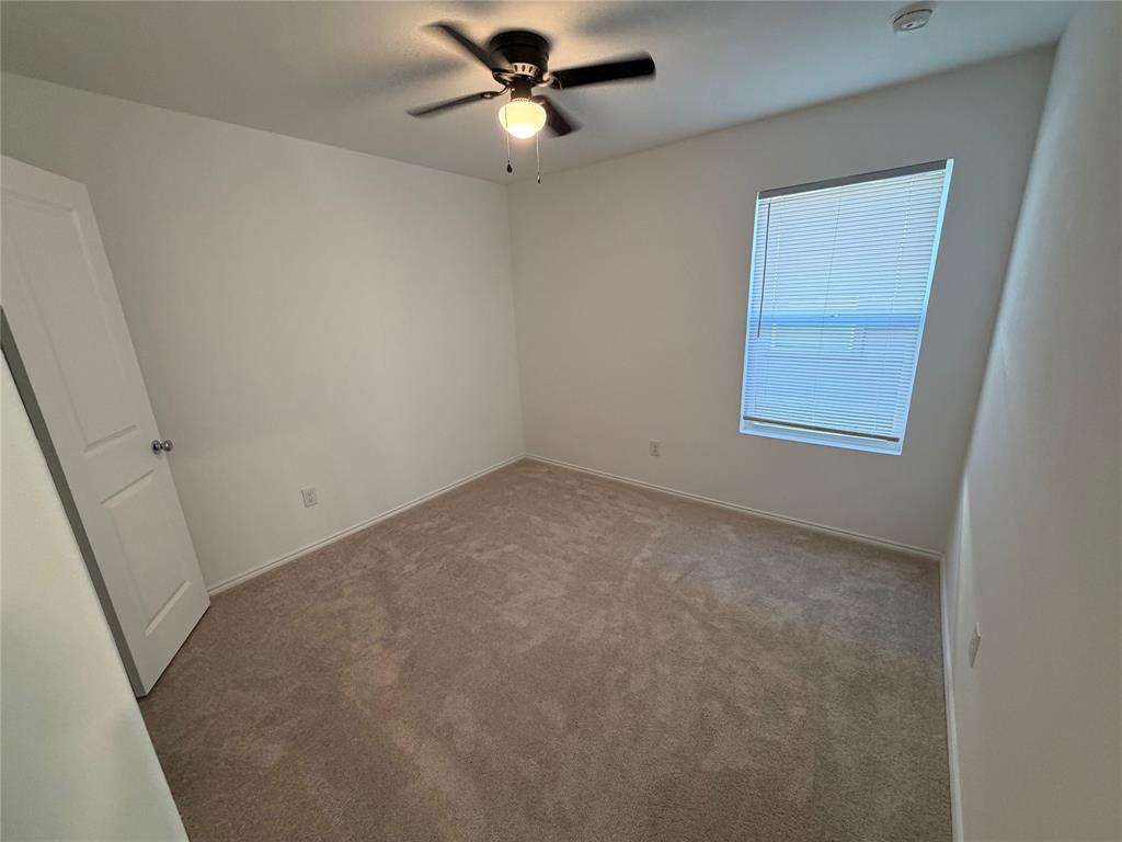 9012 Red Fox Trail McKinney, TX 75071 - Photo 26 of 35 an empty room with a window and a fan