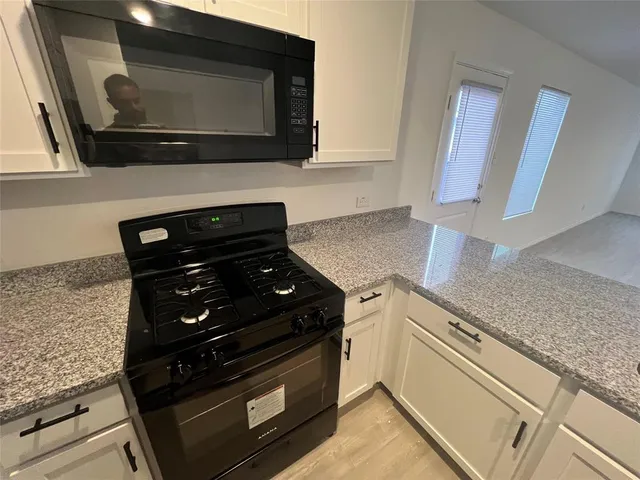a kitchen with a stove and a microwave