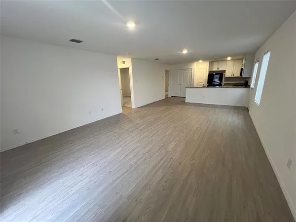 a kitchen with granite countertop white cabinets and black appliances