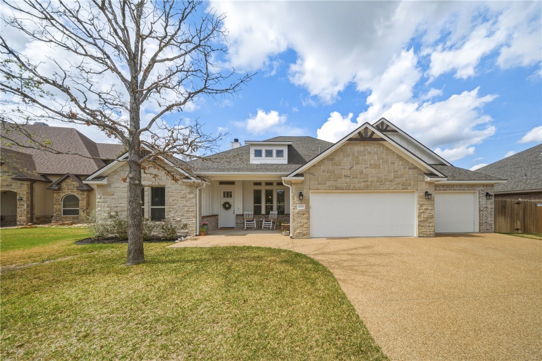 a front view of house with yard and trees around