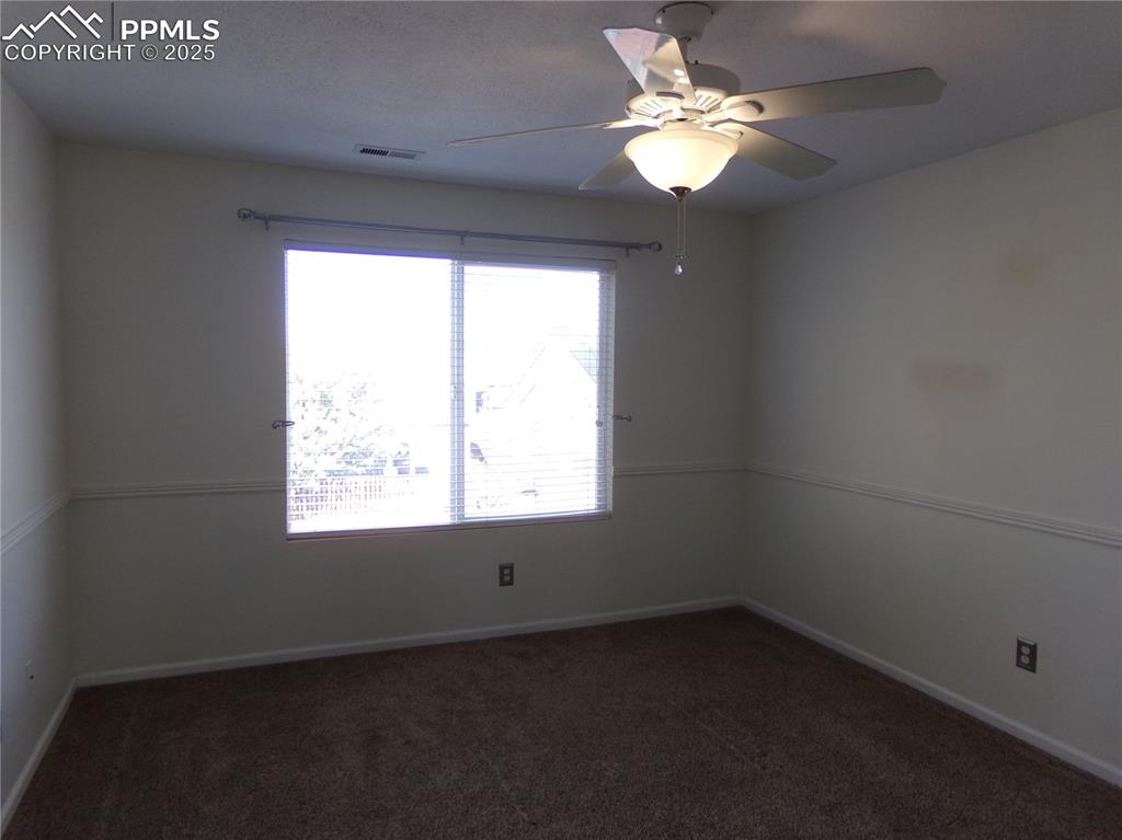 895 Rancher Drive Fountain, CO 80817 - Photo 15 of 29 an empty room with a window and a fan