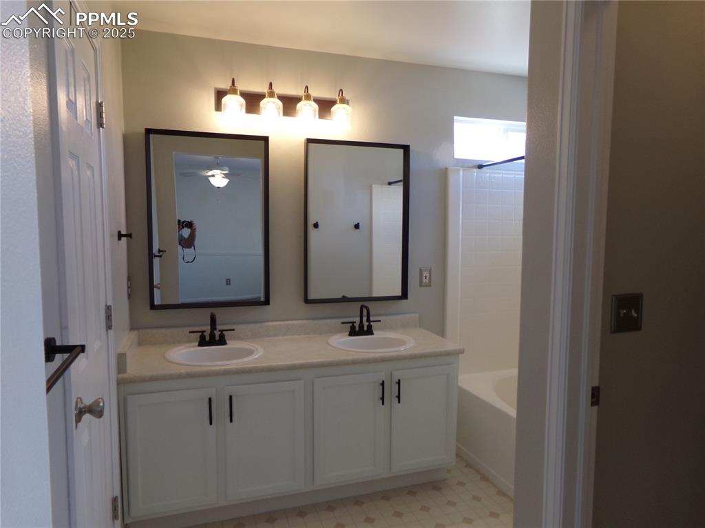 895 Rancher Drive Fountain, CO 80817 - Photo 18 of 29 a bathroom with double vanity sink and a mirror