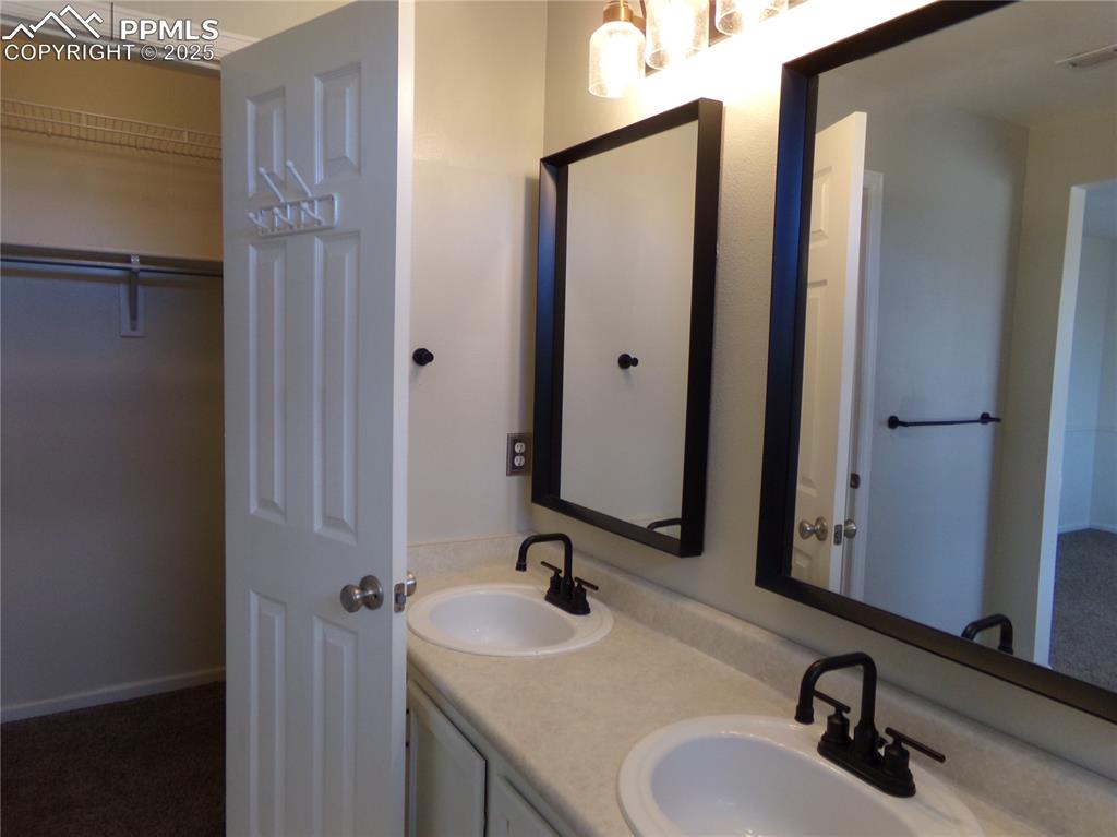 895 Rancher Drive Fountain, CO 80817 - Photo 20 of 29 a bathroom with a sink and a mirror
