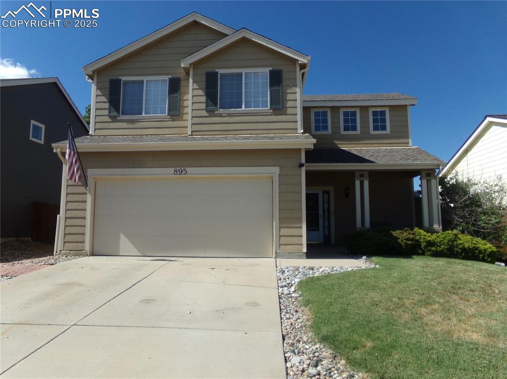895 Rancher Drive Fountain, CO 80817 - Photo 2 of 29 a front view of a house with garden