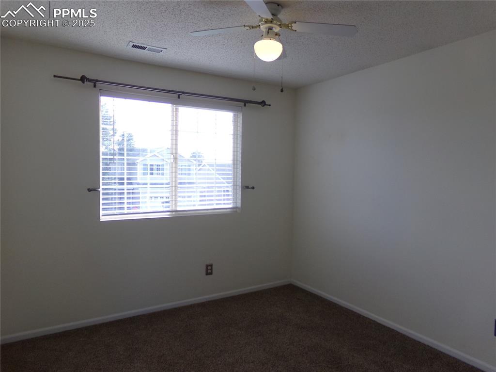 895 Rancher Drive Fountain, CO 80817 - Photo 23 of 29 an empty room with a window