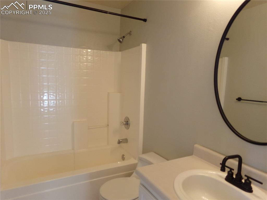 895 Rancher Drive Fountain, CO 80817 - Photo 24 of 29 a bathroom with a sink a toilet and a mirror
