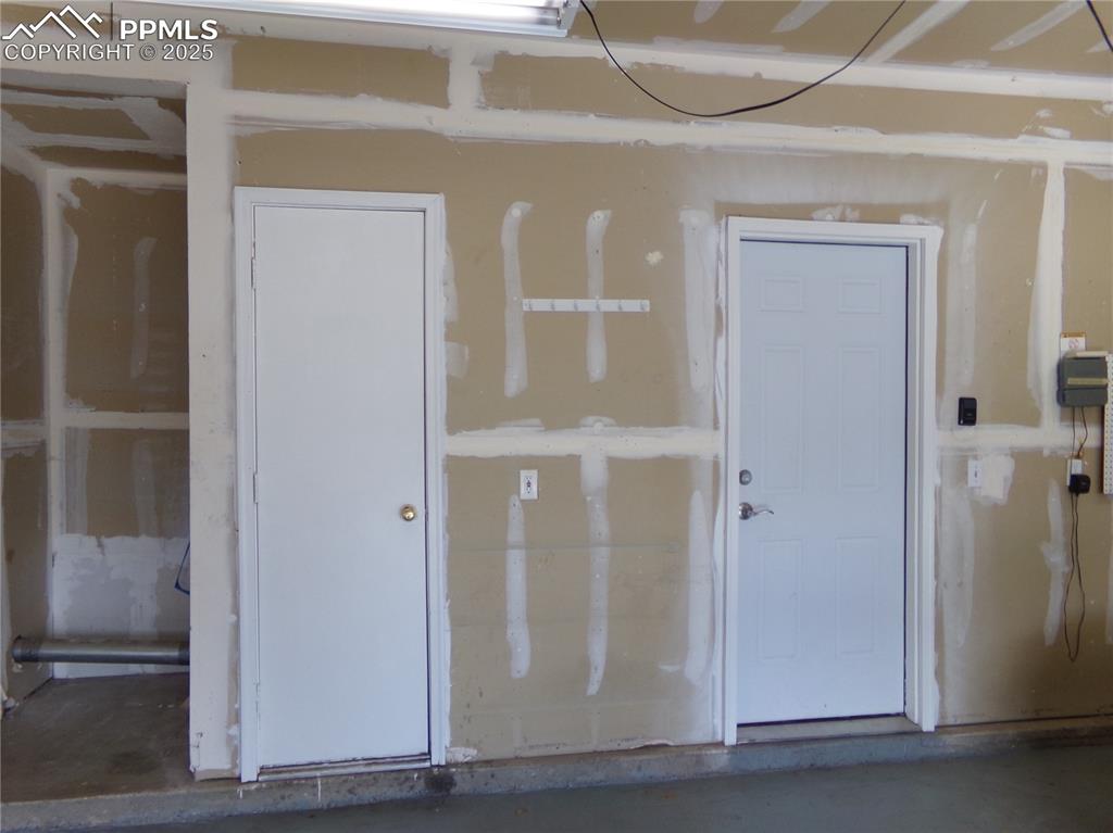 895 Rancher Drive Fountain, CO 80817 - Photo 26 of 29 a view of a hallway with wooden door