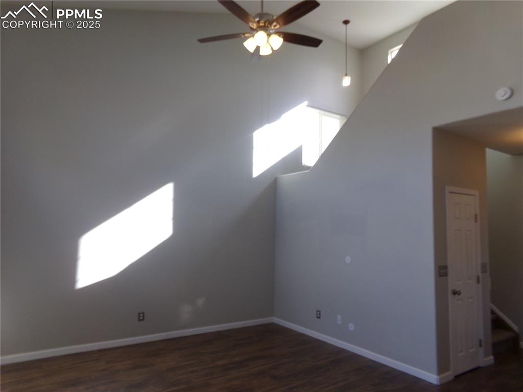 895 Rancher Drive Fountain, CO 80817 - Photo 6 of 29 an empty room with wooden floor and windows