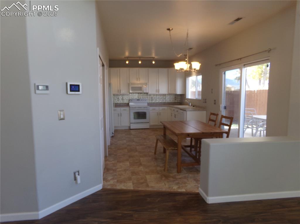 895 Rancher Drive Fountain, CO 80817 - Photo 8 of 29 a kitchen with a table and chairs in it