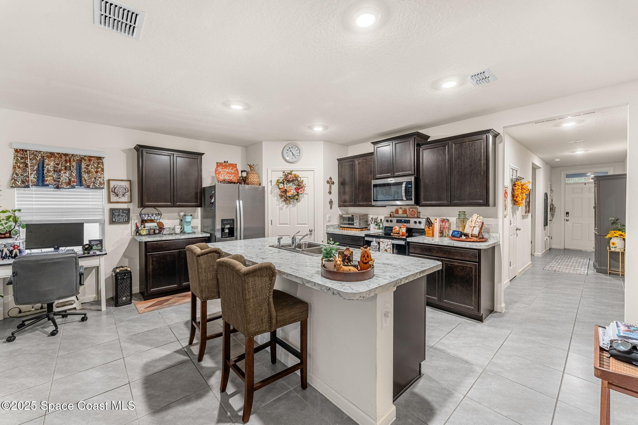 4901 Talbot Boulevard Cocoa, FL 32926 - Photo 11 of 39 a kitchen with a sink a counter top stainless steel appliances and cabinets