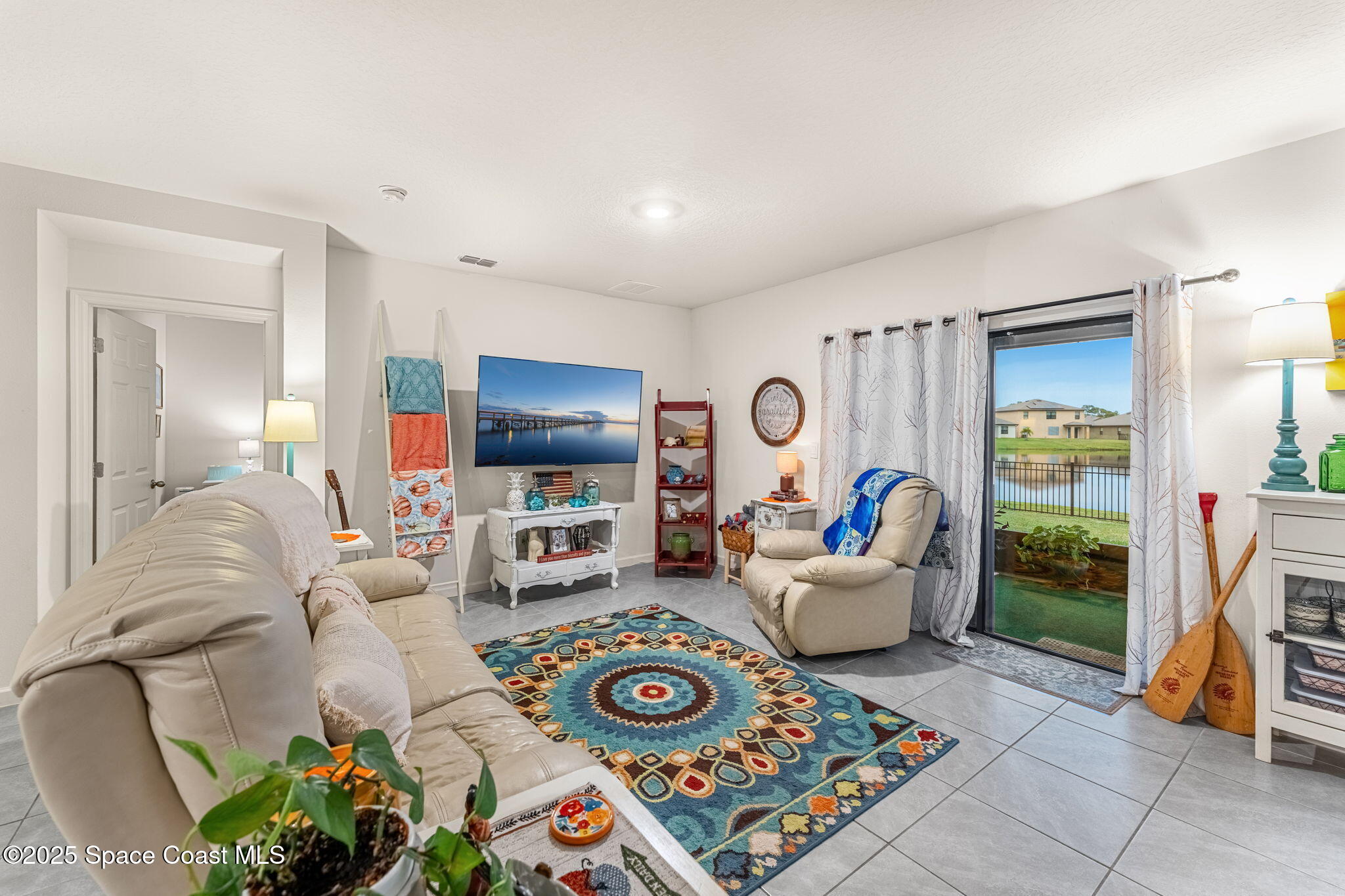 4901 Talbot Boulevard Cocoa, FL 32926 - Photo 19 of 39 a living room with furniture and a flat screen tv